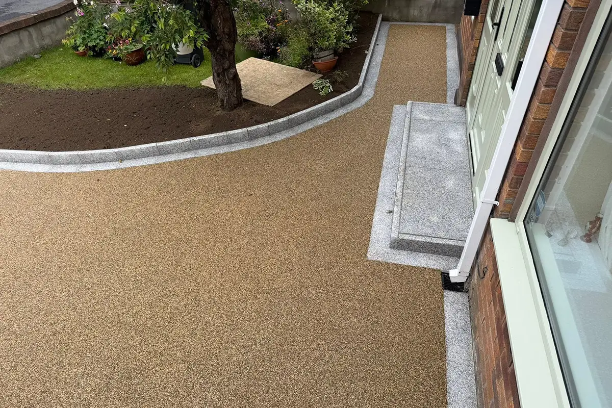 Silver granite entrance step and planting-area risers beside a resin driveway in Templeroan Dublin