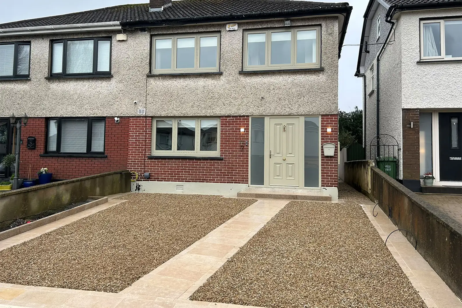 Completed gravel driveway with natural stone framing pathway and granite step at Monalea Grove Firhouse Dublin