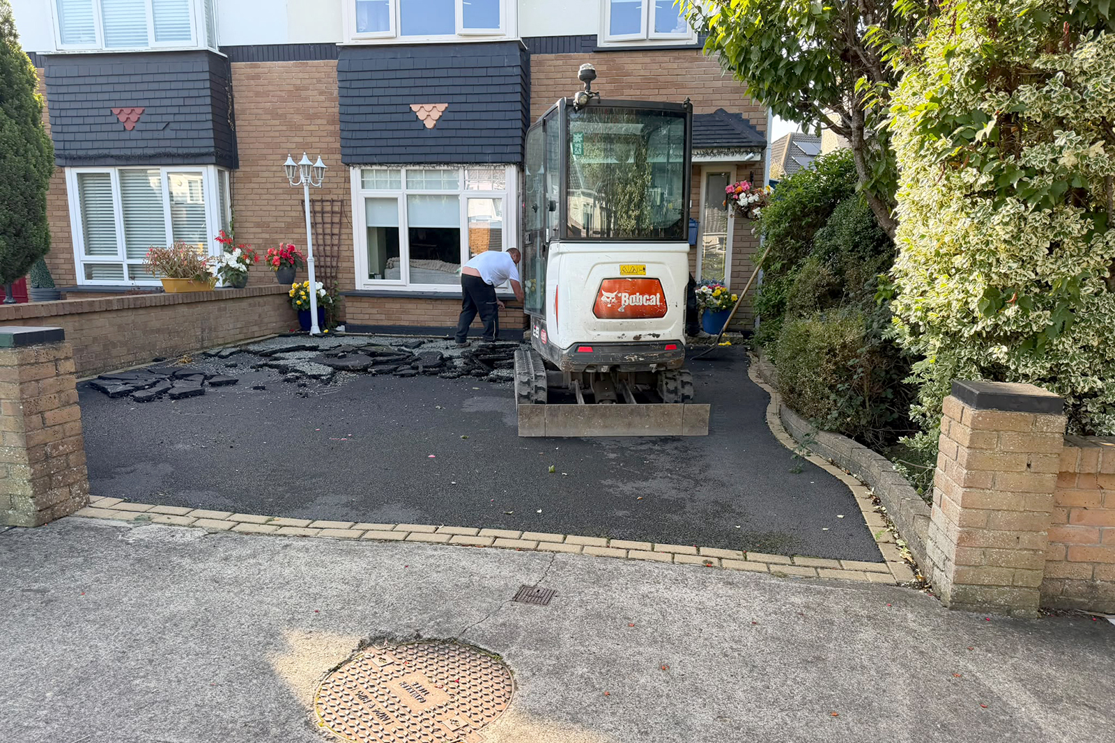 Existing uneven tarmac driveway and colour block frame at Parklands Dublin 24 before replacement