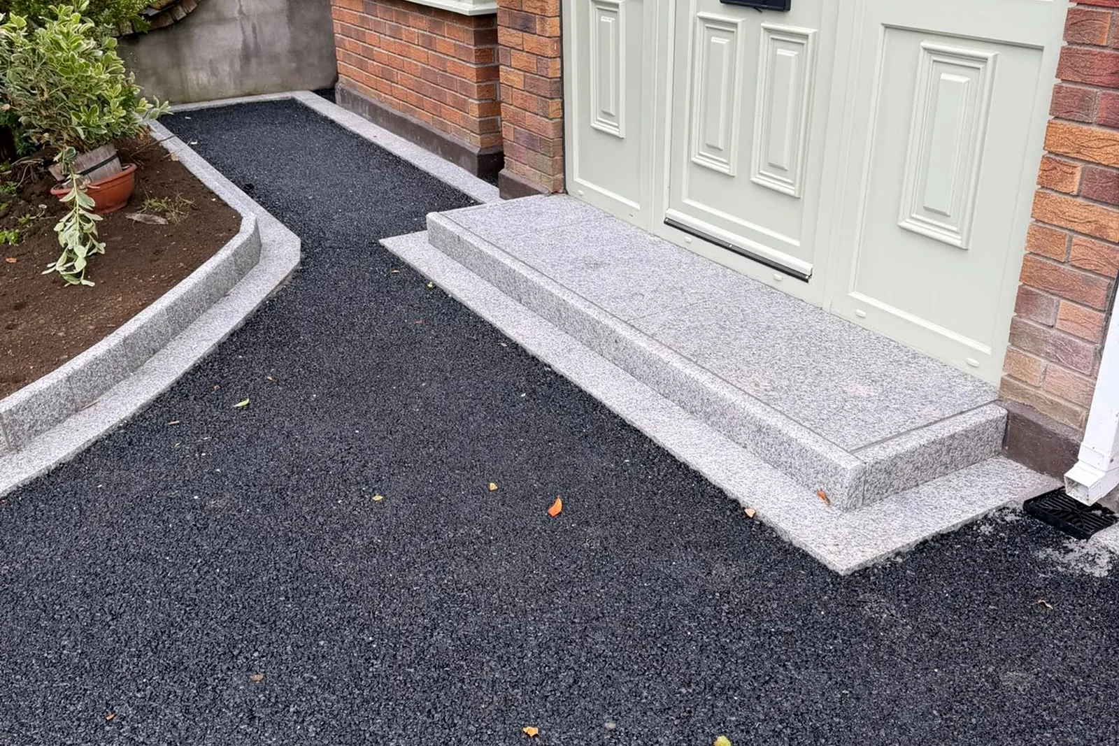 Silver granite risers framing garden beside resin driveway in Templeroan Dublin