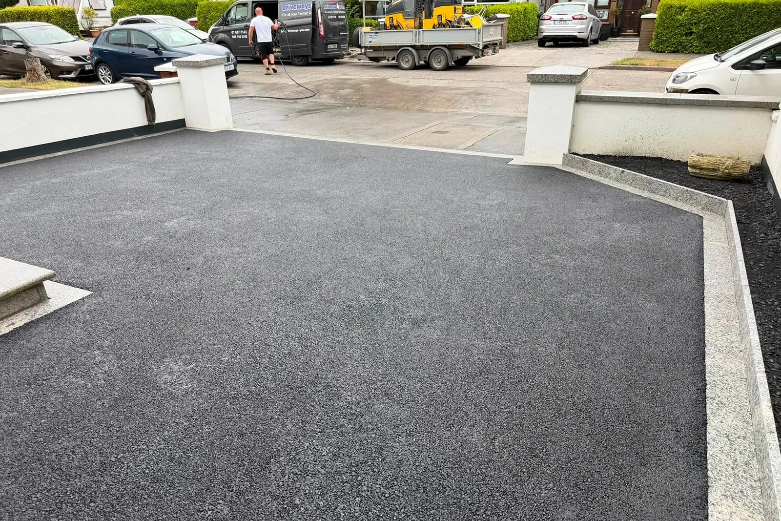 Silver granite risers creating a raised flower bed beside a tarmac driveway in Ballinteer Dublin 14