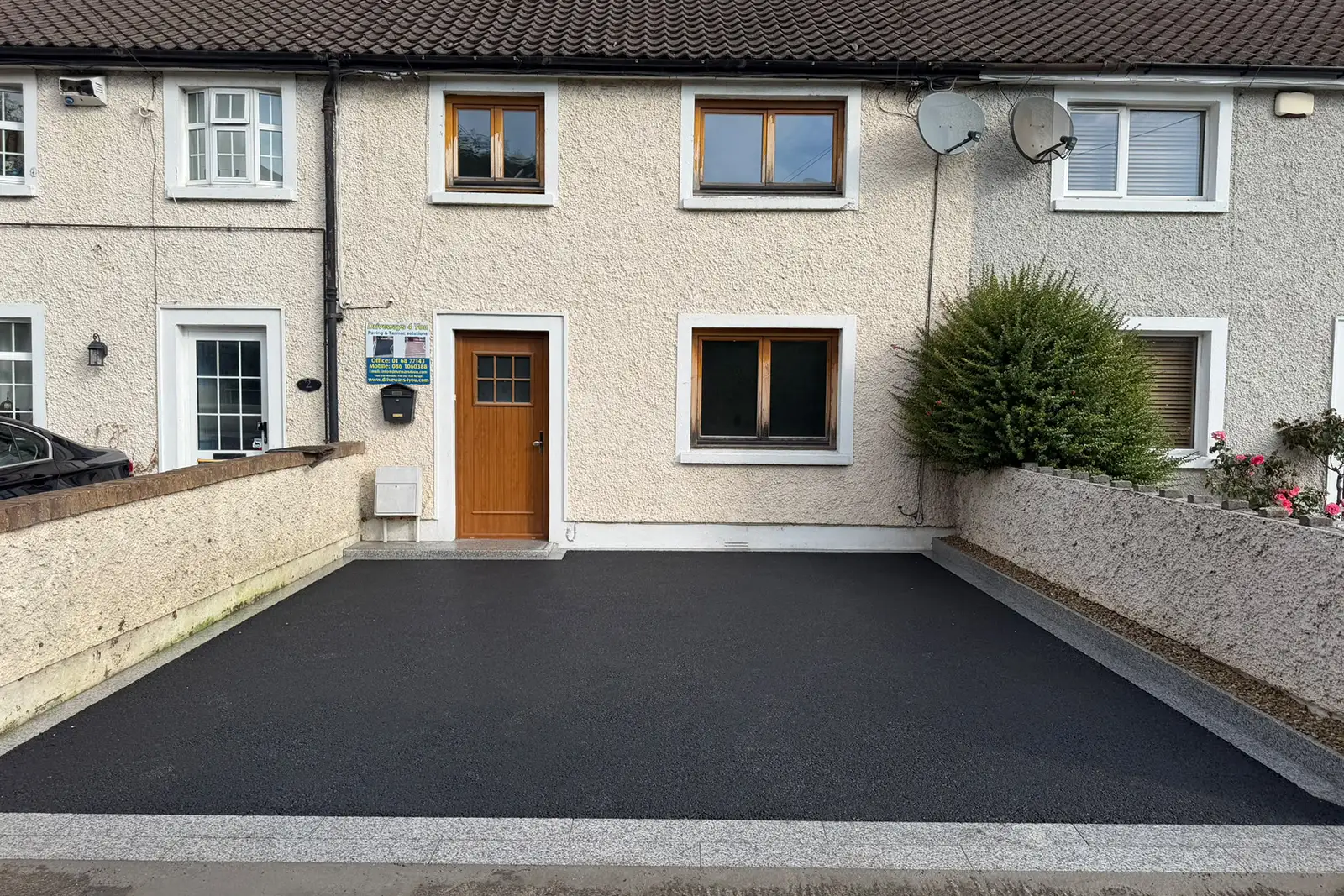 Completed SMA tarmac driveway with silver granite framing planting area risers double-row entrance border and matching step in Drimnagh Dublin