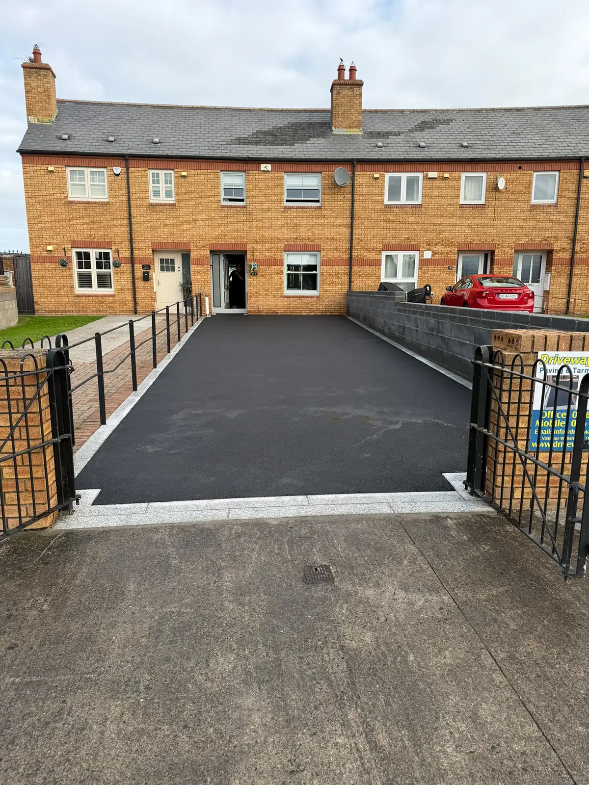 Completed SMA tarmac driveway with straight natural silver granite framing in Palmerstown Dublin